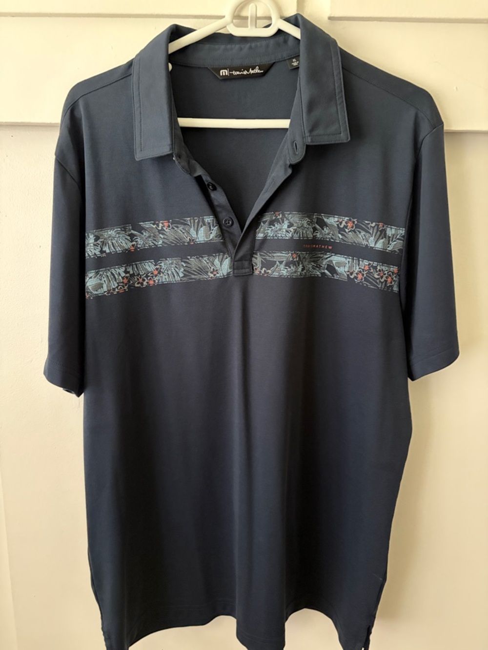 TravisMathew Navy Polo with Tropical Chest Stripes